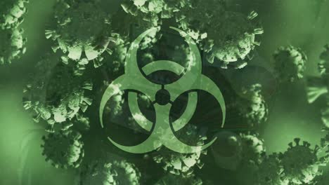 animation of biohazard sign and covid 19 cells floating over green background