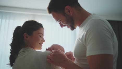 happy parents holding newborn baby