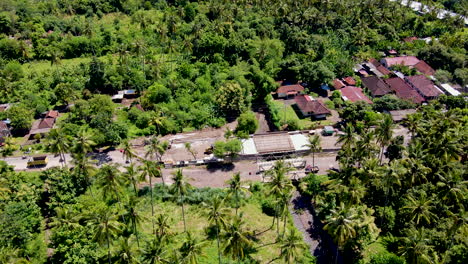 Bridge-With-Vehicles-Driving-Across-Near-Small-Town-In-West-Bali,-Indonesia-During-Sunny-Day