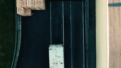 Aerial-of-merchandise-delivery-station,-truck-is-approaching-to-unloading-spot