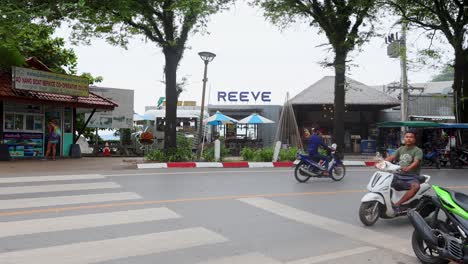 vehicles and people navigating a busy street