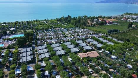 Beautiful-Italian-condo-camping-townhomes-in-countryside-vineyards-by-lake-garda,-aerial-parallax