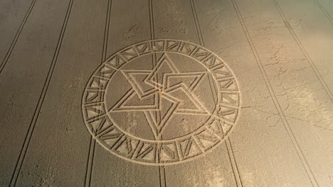 mysterious west meon golden barley field crop circle pattern aerial view descending towards design
