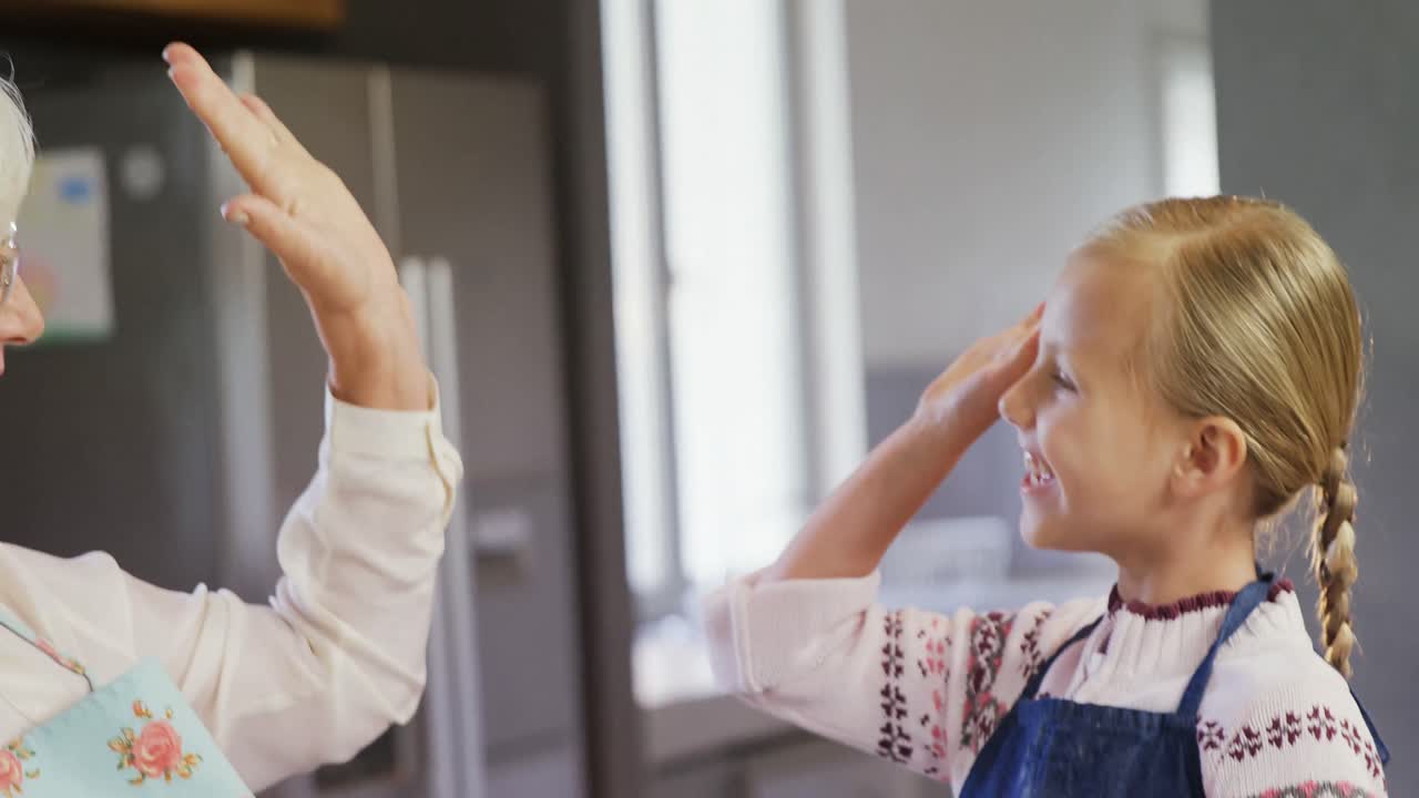 Grandmother and granddaughter giving high five 4k