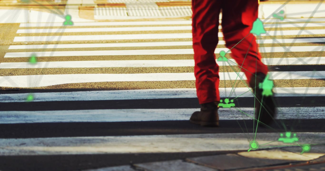 Person Walking Across Pedestrian Crosswalk with Digital Network Overlay