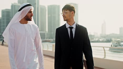 businessmen discussing on a city waterfront