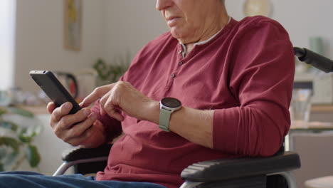 elderly man in wheelchair scrolling through phone