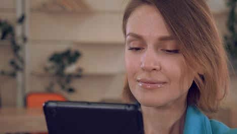 cerca de la cara alegre de la mujer con el dispositivo digital
