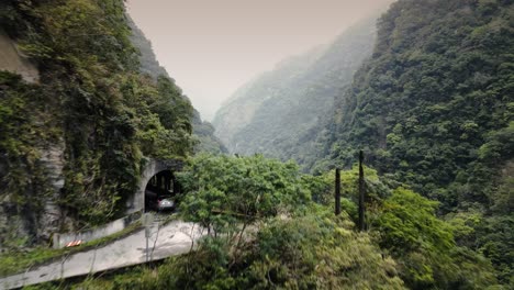 Car-travelling-along-Remote-Mountainous-Area-Road-Steep-River-Valley-with-Tunnels-in-Taiwan-Taroko-Unfinished-Provincial-Highway