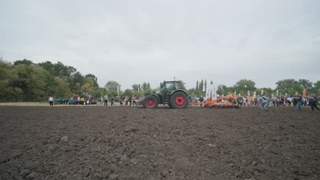 demonstration of agricultural machinery at an exhibition. tractors operate in the field, showcasing their capabilities and performance in action