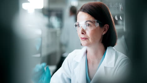 scientist in lab with safety glasses
