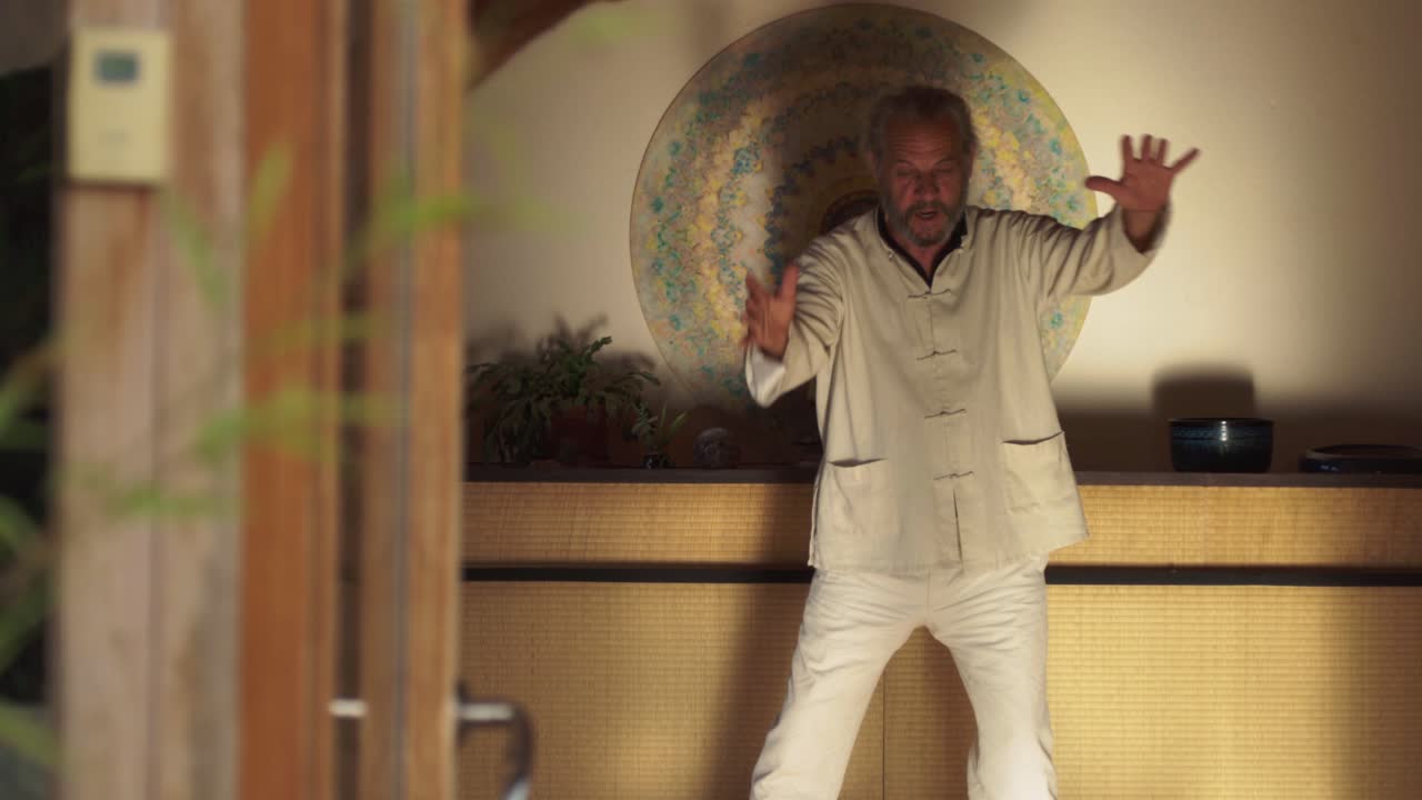 Man performing chi kung exercise in spacious room