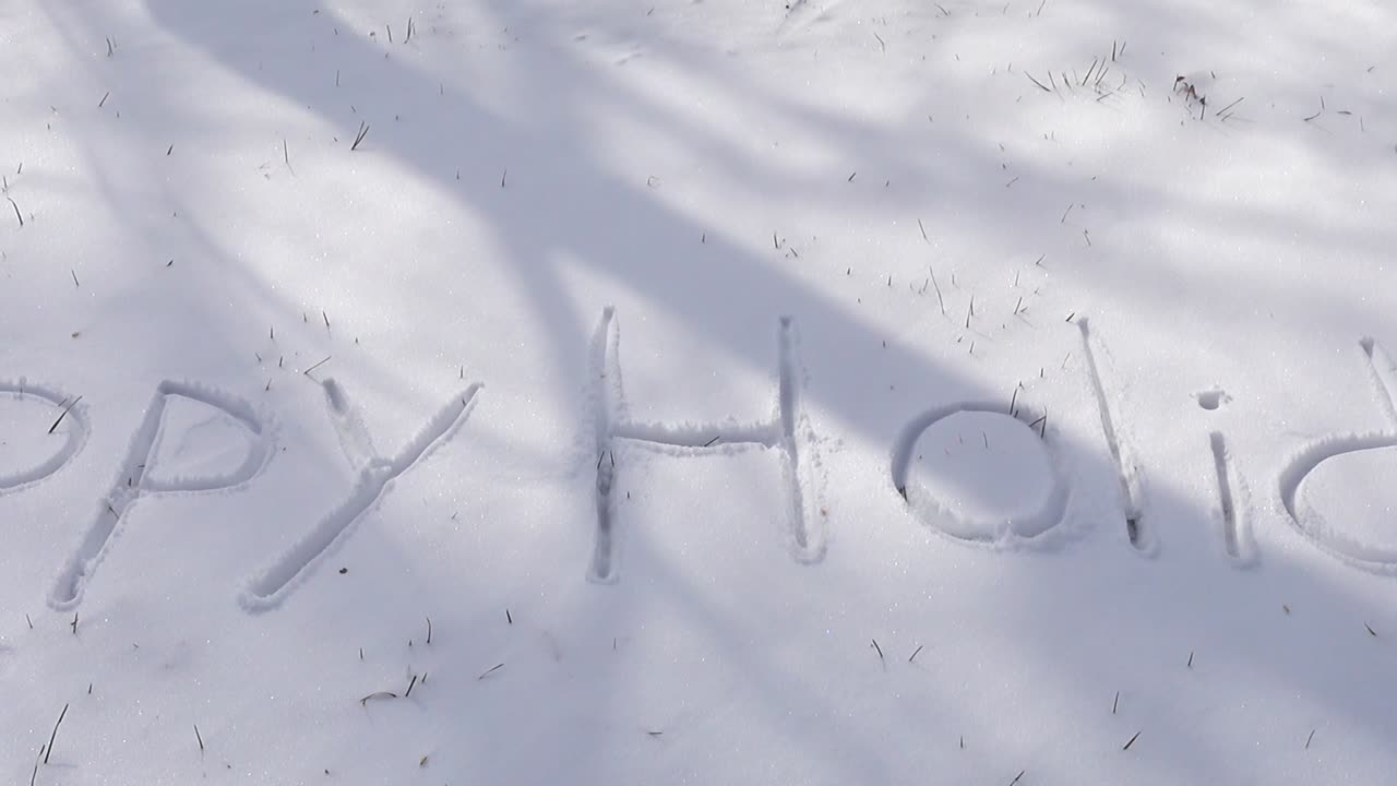 Inscription of happy holidays on snow. Shooting in the winter