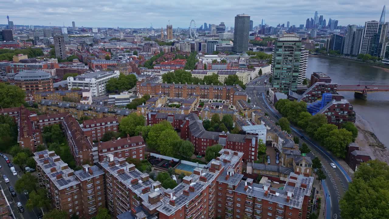 Pimlico neighborhood and riverside with Millbank Tower and Big Ben in background, London cityscape. Aerial drone forward