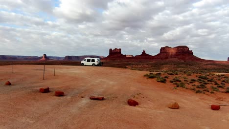 Drone-shot-flies-past-van-lifers-towards-Monument-Valley