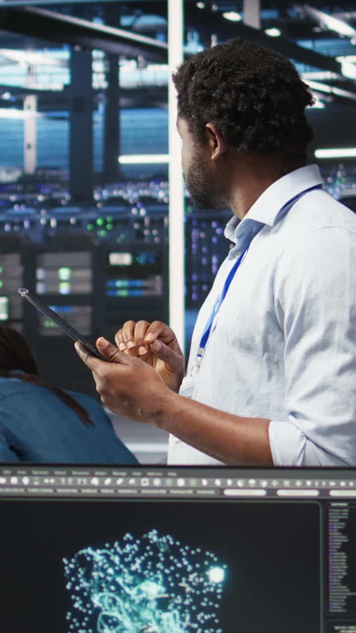 Vertical Video Data Center Engineer Using Tablet To Interpret Ai Generated Data Analytics Graphs