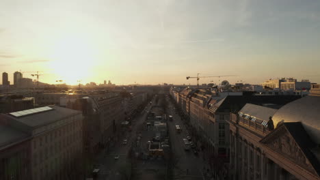 Antena:-Espectacular-Vuelo-Bajo-A-Través-De-La-Concurrida-Calle-Berlín,-Alemania-Hacia-La-Puerta-De-Brandenburgo-En-La-Hermosa-Luz-Dorada-Del-Atardecer