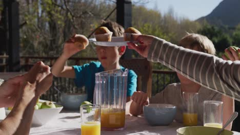 family eating breakfast together outdoors