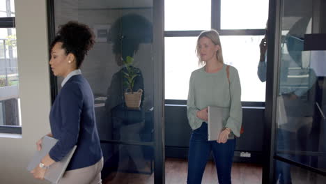 diverse business people walking into conference room with copy space