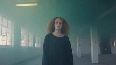 mujer joven de moda en un almacén abandonado