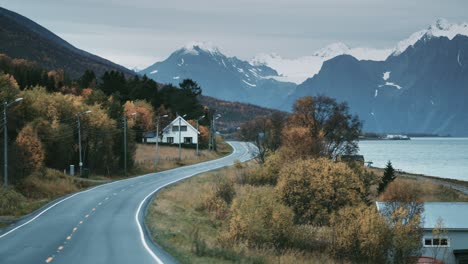 narrow two-lane road following the fjord shoreline