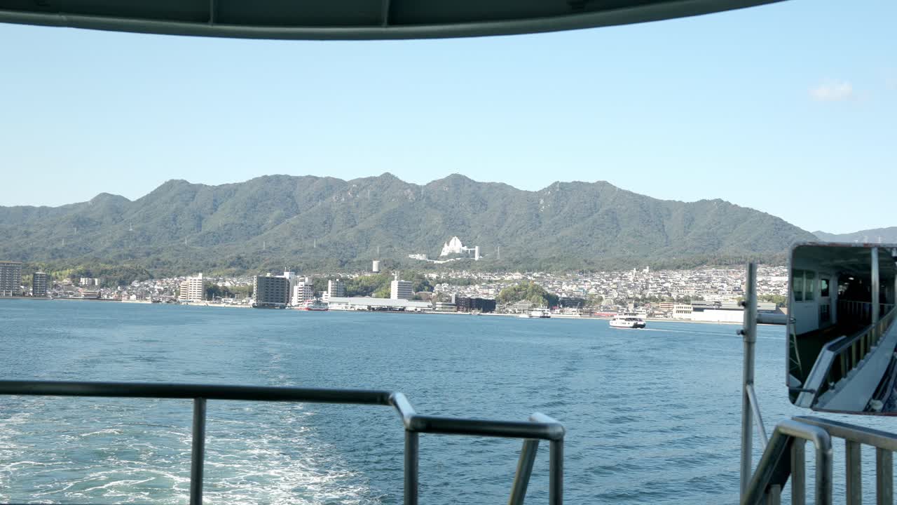 A view of the surroundings of Hiroden-Miyajimaguchi Station in Hiroshima taken from a ferry boat.