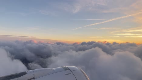 sunset in the clouds from an airplane window