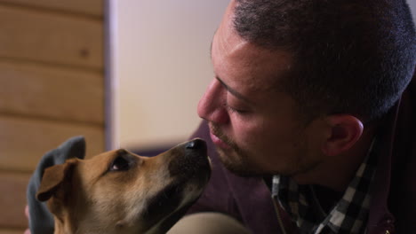 Dog-an-owner-look-at-eachother-with-love-after-a-quick-wipe-down-after-muddy-outdoor-walk---close-up-on-faces