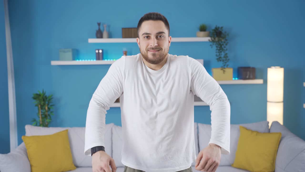 젊은 운동 선수가 집에서 운동을 하고 팔과 어깨를  ⁇ 고 따뜻하게 합니다.