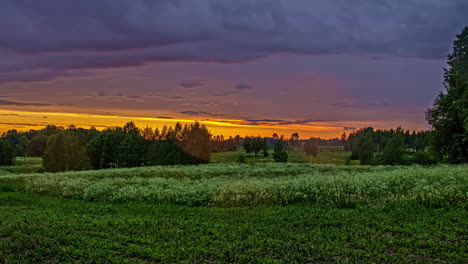 an orange sunset with droplets on the lens as a light rain falls - time lapse