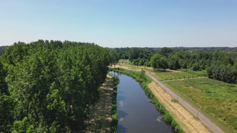 Aerial-drone-shot-above-a-nature-park,-water-canal,-abandoned-kastel-of-Almere-city,-province-Flevoland,-Netherlands