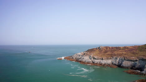 aerial fly past of a slate cliff headland in north devon on a summer’s morning
