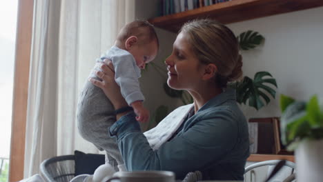 happy young mother playing with baby at home smiling enjoying motherhood playfully caring for cute infant