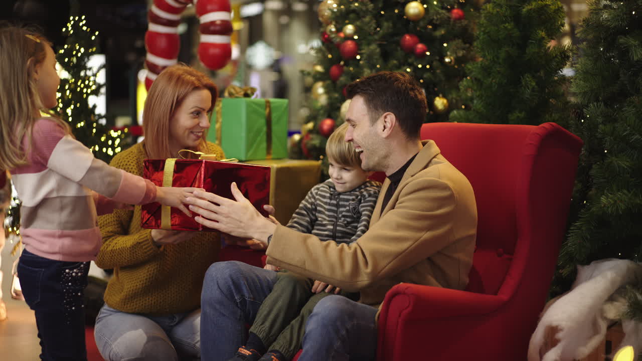 A family celebrating Christmas together with gifts