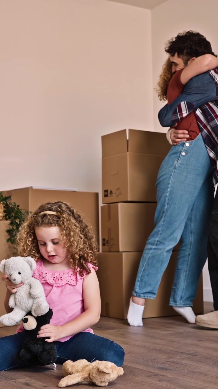 Family Moving Into New Home With Cardboard Boxes