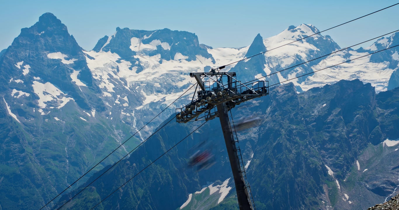 Seggiovia panoramica in movimento davanti a montagne innevate