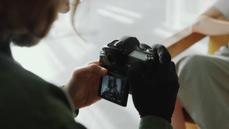 photographer taking black-and-white portraits of female model with camera