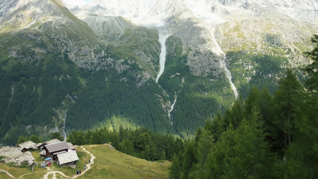 Aerial: Arolla's Blue Lake with mountain reflection during the day in Val d'Herens, canton of Valais, Switzerland, push in drone shot