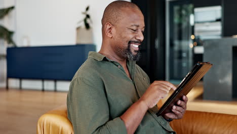 man using a tablet in his living room