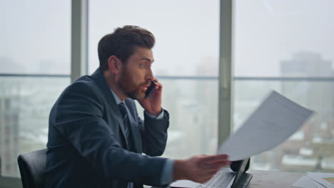 frustrated ceo talking cellphone workplace dissatisfied business report closeup