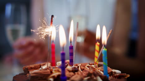 Birthday-cake-with-sparkler-and-burning-candles,-close-up
