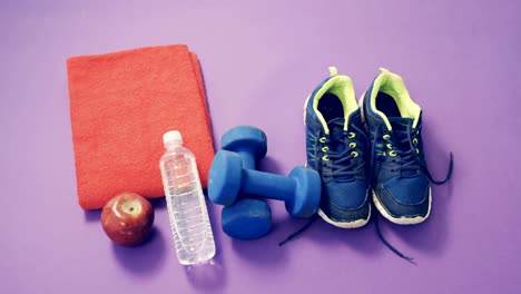 shoes, dumbbells, water bottle, apple and napkin