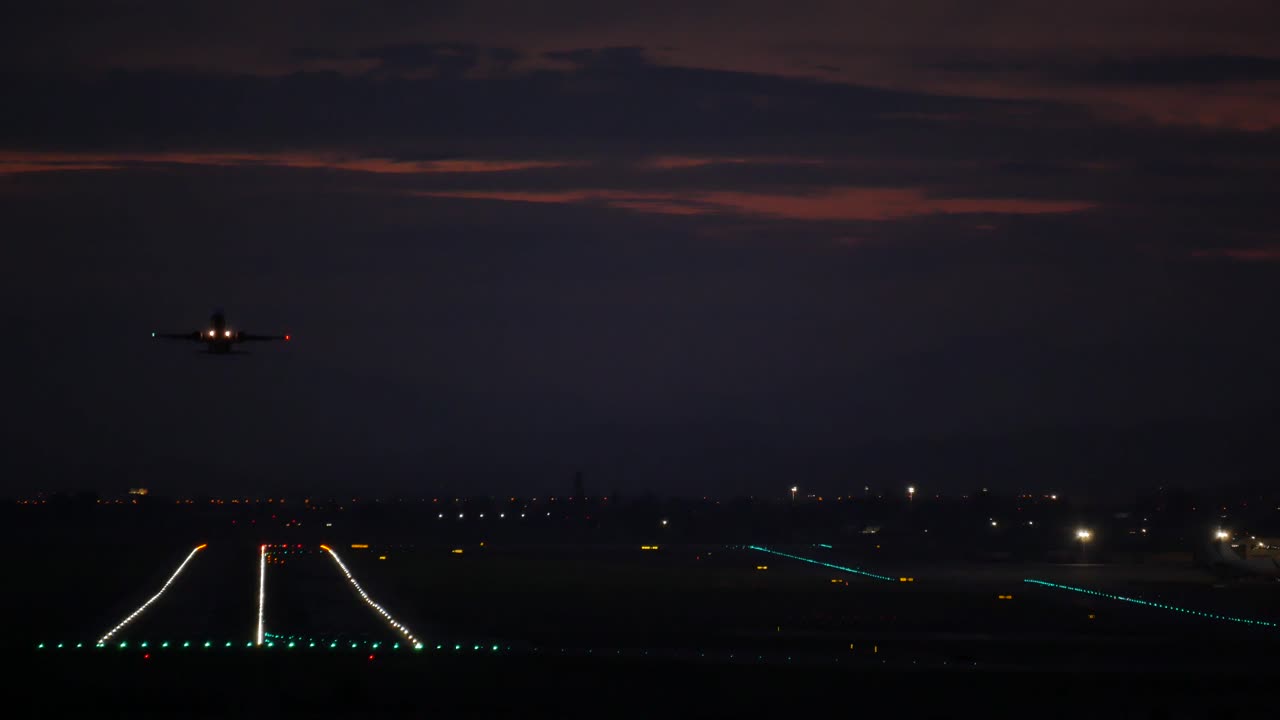 Aircraft taking off at night. Alicante airport, Spain