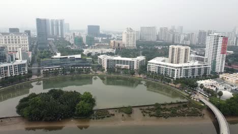 drone descends above district 7 ho chi minh city pond water feature