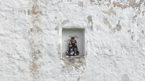 statue of st. olaf above the main door of vormsi church on vormsi island. estonia.