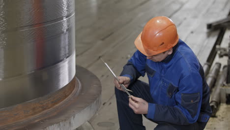 industrial worker inspecting metal component