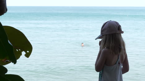 blonde caucasian girl with homesickness looking out into tropical ocean, ready for color grading