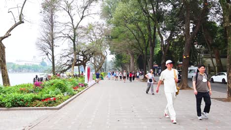 people walking along a scenic path in hanoi