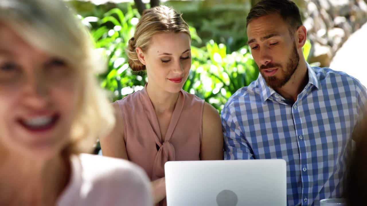 pareja usando una computadora portátil en un restaurante