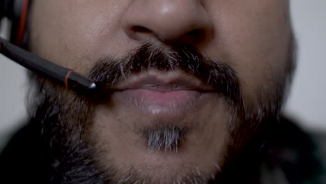 extreme close up bearded ethnic minority male talking on boom mic